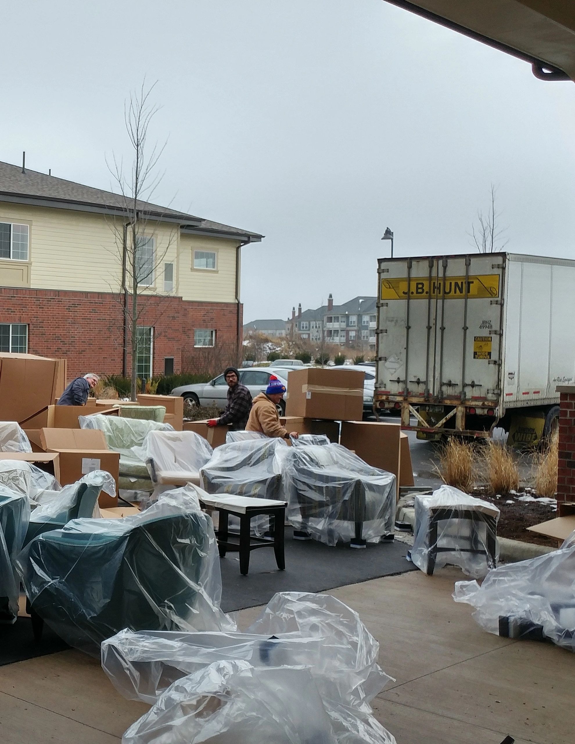 Furniture delivery team unloading items for installation